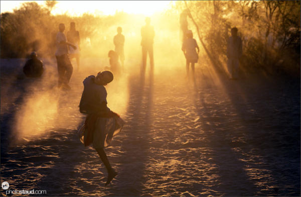 Bushman children playing in the sand, Den/ui village, Bushmanland, Namibia