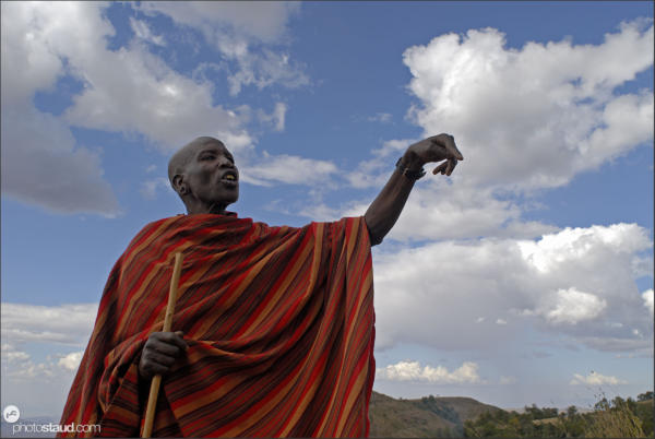 Samburu warrior covered in red blanket gesturing, Kenya