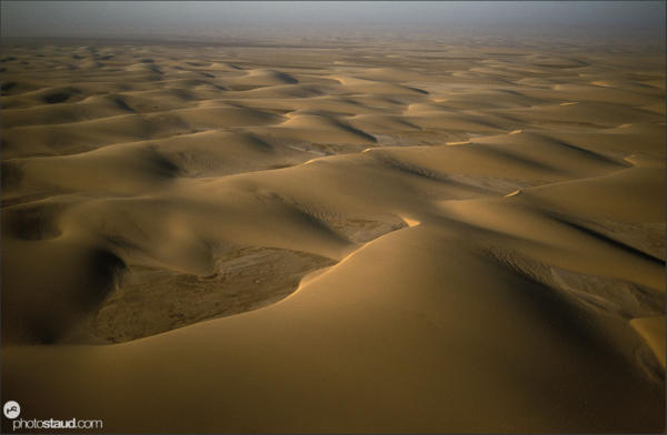 Sand dunes of the Namib Desert disappearing in haze - Aerial photograph
