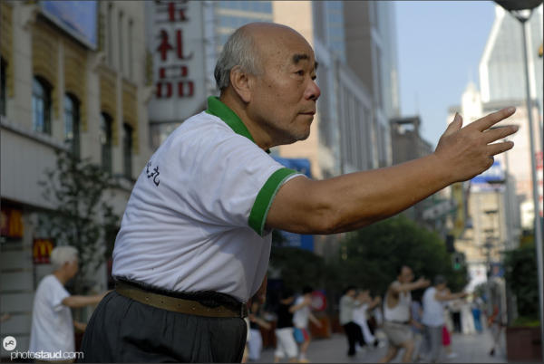 Chinese people practicing tai-chi on the Nanjing-lu road, Shanghai, China