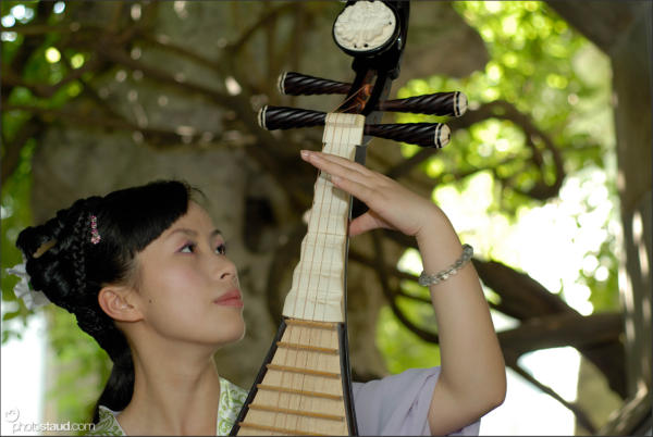 Chinese woman playing pipa – traditional four-stringed lute, China